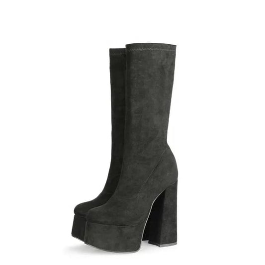 Black suede retro chunky platform boots. Round toe and block heel give it a 60's and 70's inspired twist. Knee high suede boots.