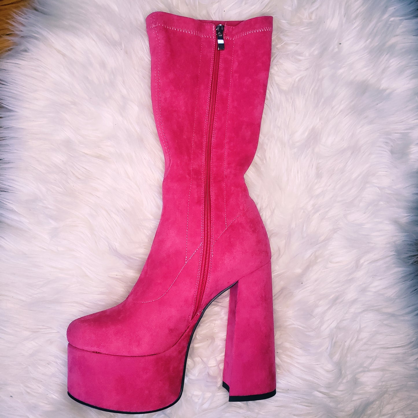 Pink suede retro chunky platform boots. Round toe and block heel give it a 60's and 70's inspired twist. Knee high suede boots.