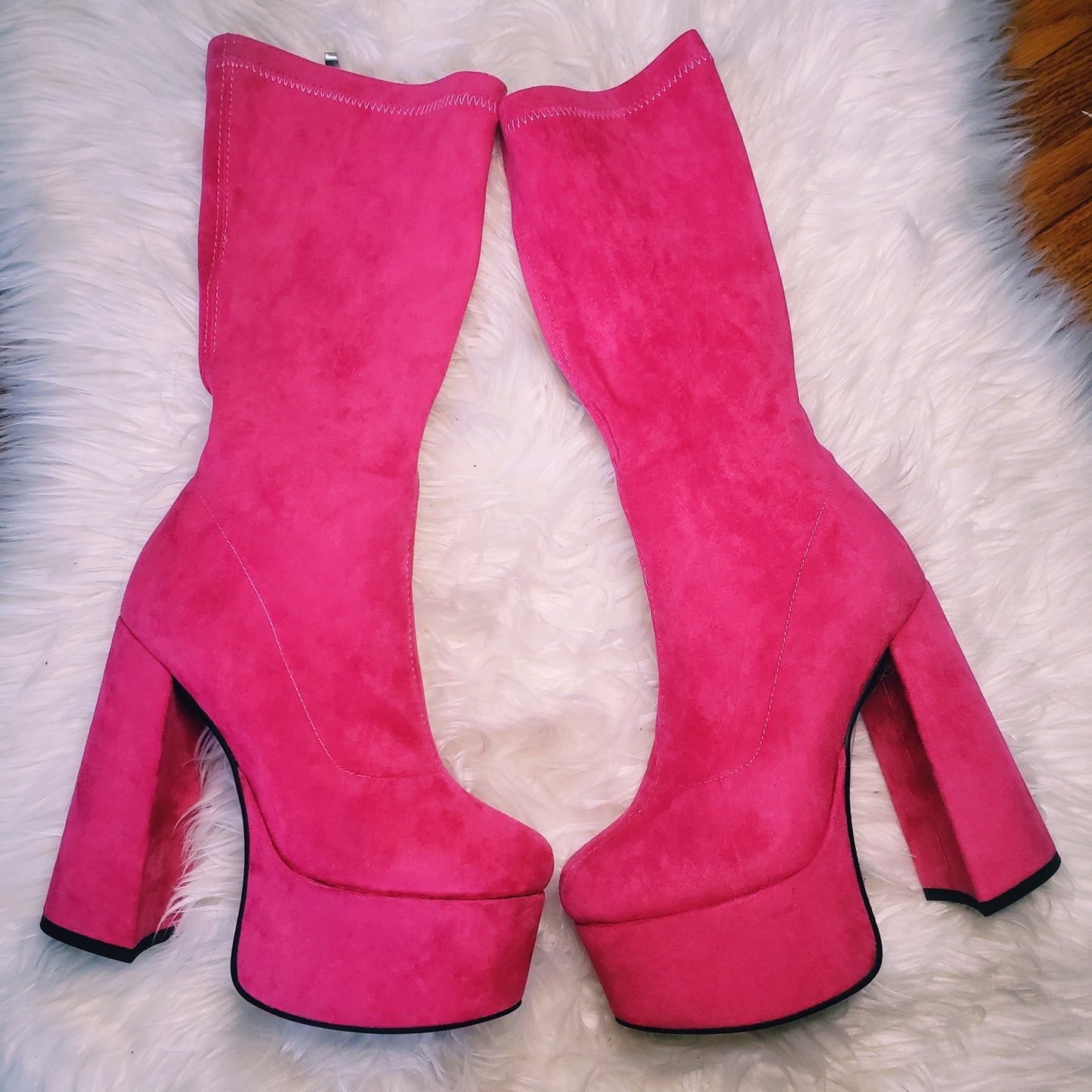 Pink suede retro chunky platform boots. Round toe and block heel give it a 60's and 70's inspired twist. Knee high suede boots.