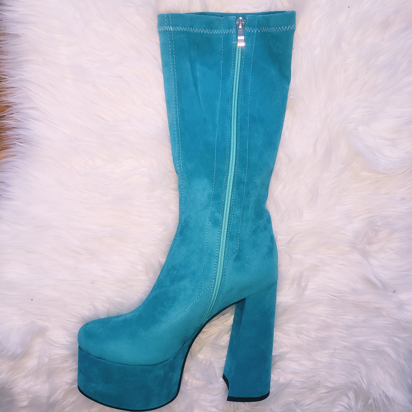 Teal blue suede retro chunky platform boots. Round toe and block heel give it a 60's and 70's inspired twist. Knee high suede boots.