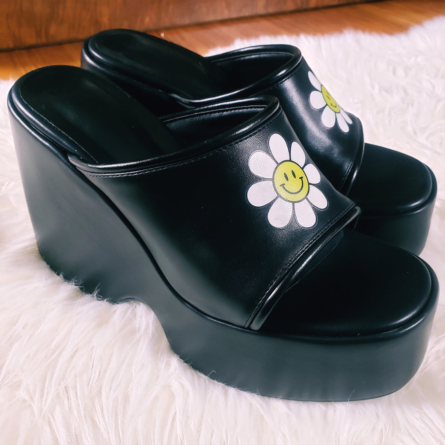 Black Platform Sandals with smiling daisy graphic on the front upper. Open toe flatform sandals. Chunky platform style, 90s and 70s inspired.
