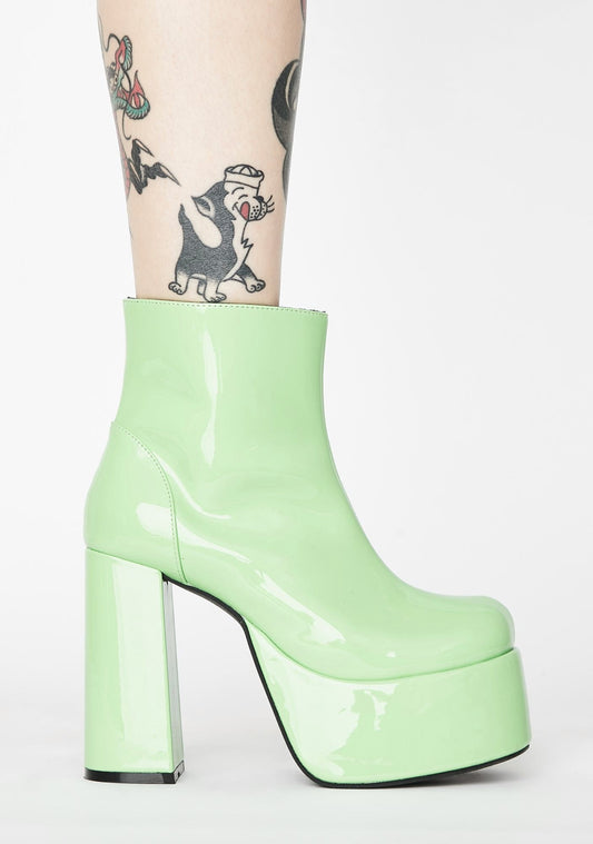 Glossy pastel green patent leather platform gogo boots. Ankle length with round toe and chunky block heel. Inspired by the 1960's gogo boots.