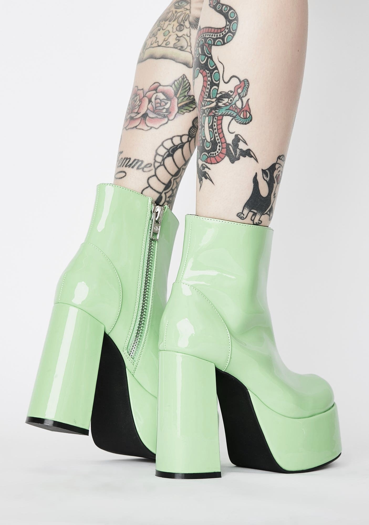 Glossy pastel green patent leather platform gogo boots. Ankle length with round toe and chunky block heel. Inspired by the 1960's gogo boots. Zip up closure.